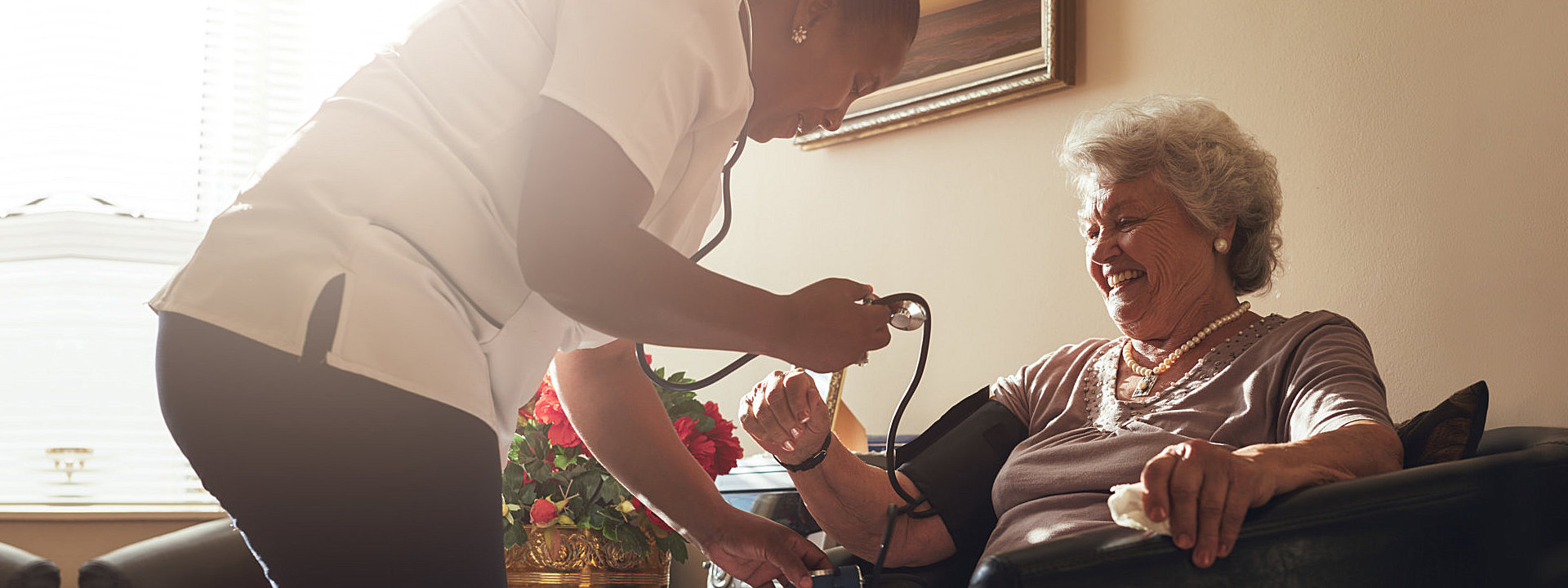 caregiver taking the blood pressure of patient